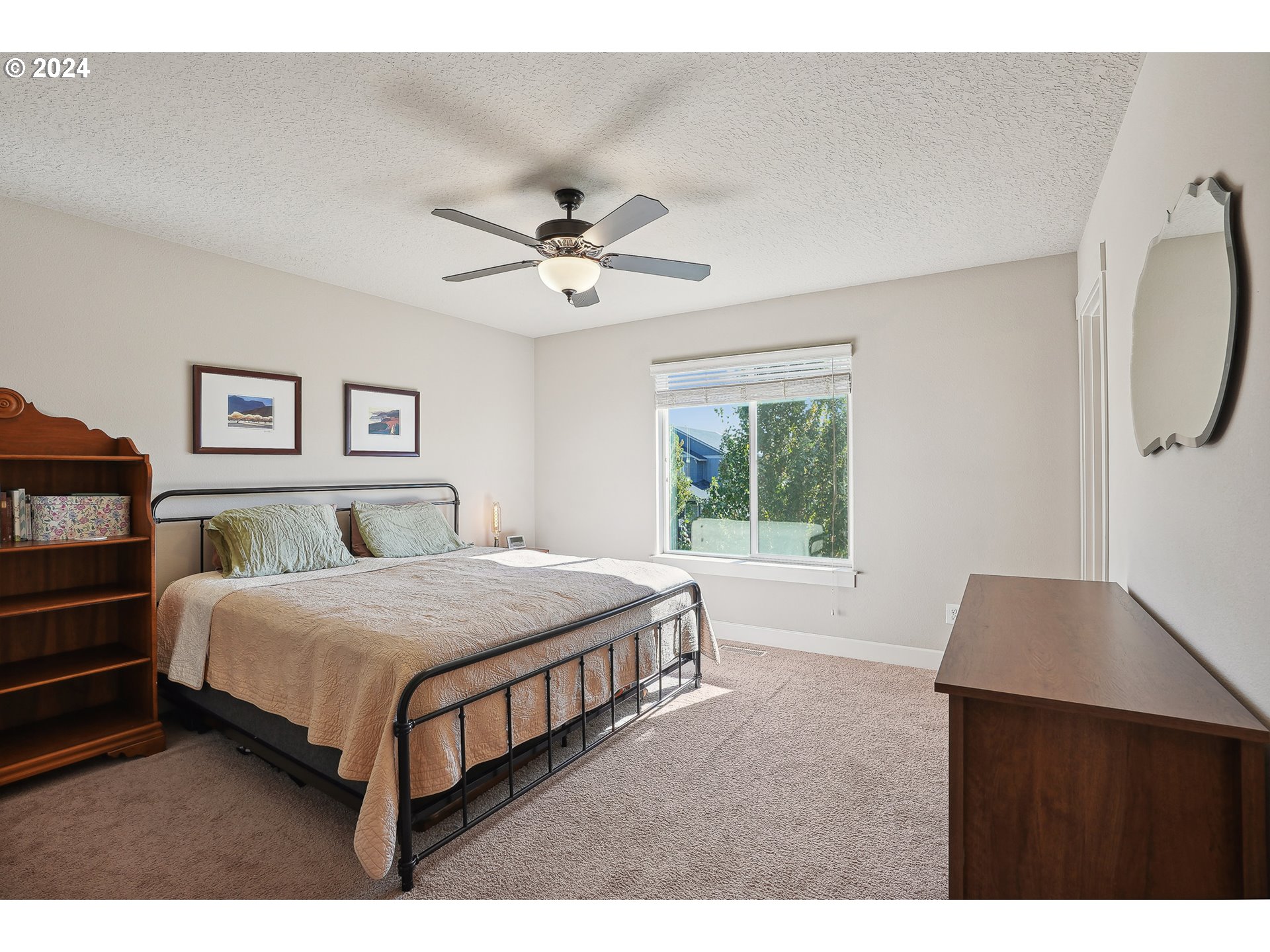 3520 Northeast Spruce Drive Camas, WA 98607 - Photo 21 of 38 a bedroom with a bed a window and a chandelier