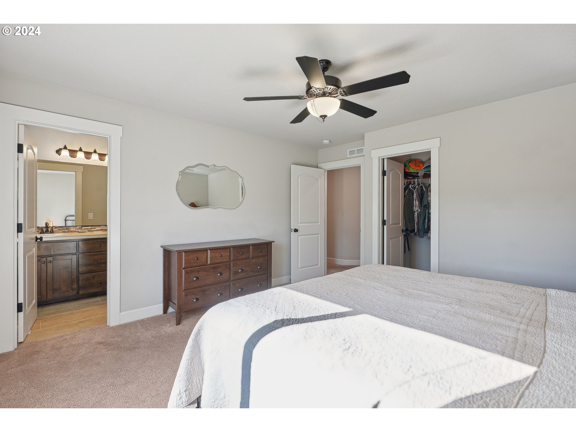 3520 Northeast Spruce Drive Camas, WA 98607 - Photo 23 of 38 a bedroom with a bed and a chandelier