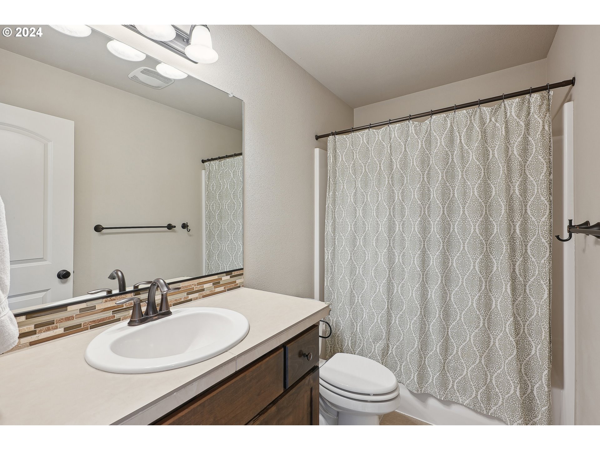 3520 Northeast Spruce Drive Camas, WA 98607 - Photo 25 of 38 a bathroom with a sink vanity mirror and toilet