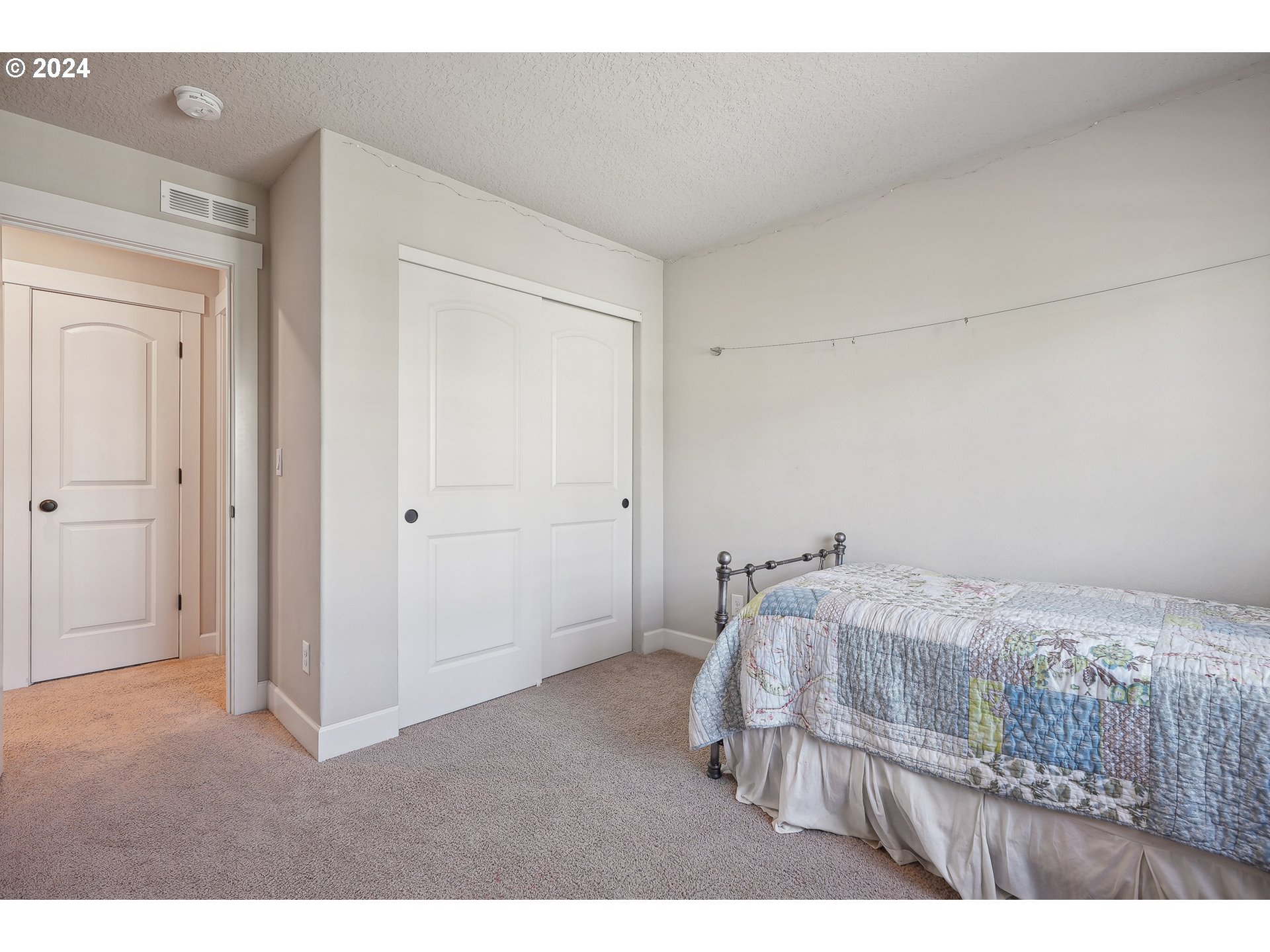 3520 Northeast Spruce Drive Camas, WA 98607 - Photo 29 of 38 a bedroom with a bed and a mirror