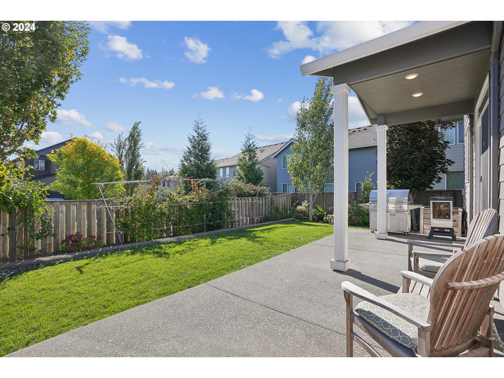 3520 Northeast Spruce Drive Camas, WA 98607 - Photo 32 of 38 a view of a backyard with couches plants and large tree