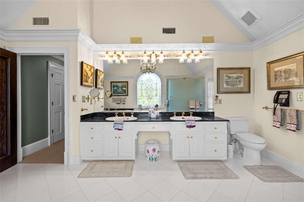 5225 Chalybeate Springs Road Woodland, GA 31836 - Photo 100 of 100 a large white kitchen with stainless steel appliances a stove a oven and white cabinets with wooden floor