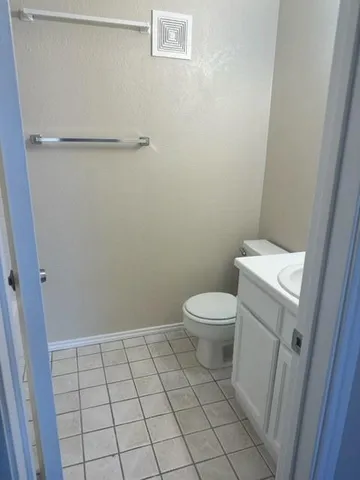 a white toilet sitting next to a shower