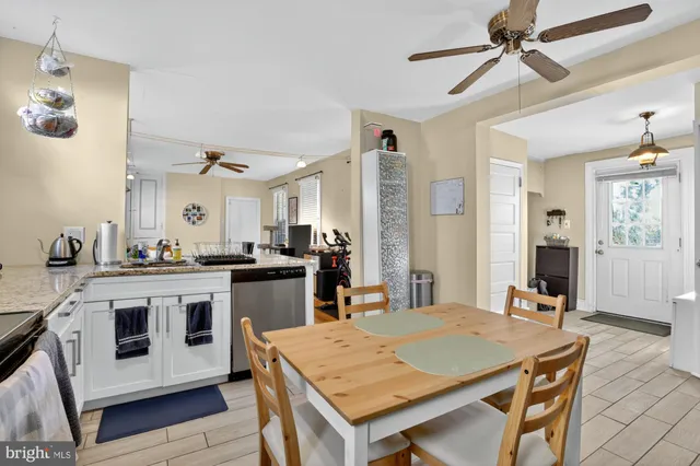 a kitchen with a stove a table and chairs