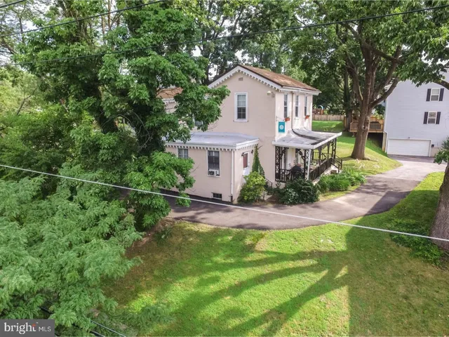 a view of a house with a yard and sitting area