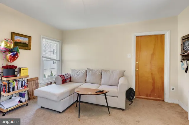 a living room with furniture and a bookshelf