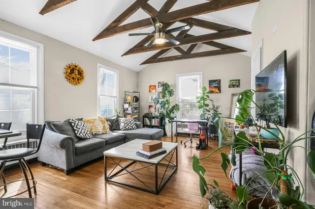 a living room with patio furniture and a flat screen tv