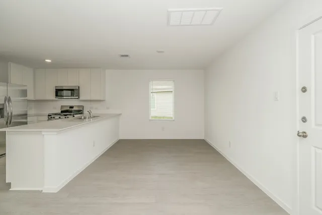 a view of kitchen with white cabinets