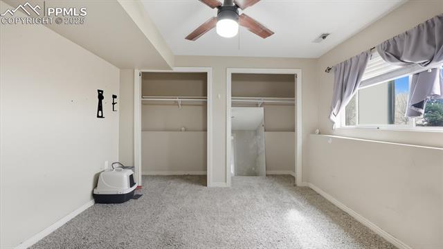 9715 Bar B Road Fountain, CO 80817 - Photo 25 of 34 Lower Level Primary Bedroom with neutral carpet, lighted ceiling fan, and double closets.