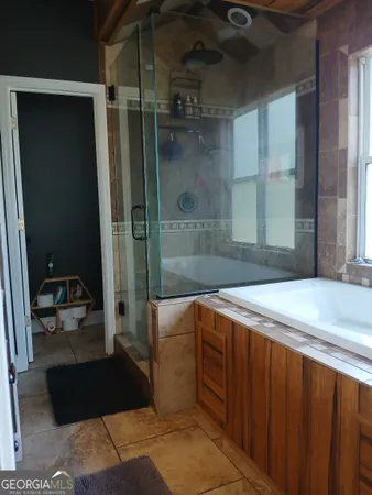 a bathroom with a bathtub and a shower