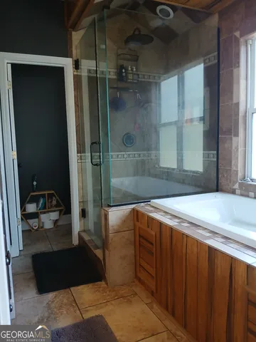 a bathroom with a bathtub and a shower
