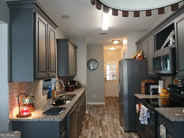 a view of a workspace with furniture and wooden floor