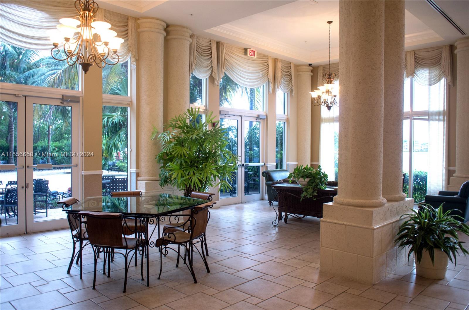 17100 North Bay Road, Unit 1402 Sunny Isles Beach, FL 33160 - Photo 19 of 25 a dining room with furniture a large window and potted plants