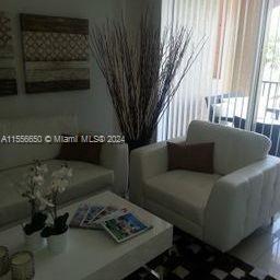 17100 North Bay Road, Unit 1402 Sunny Isles Beach, FL 33160 - Photo 7 of 25 a living room with furniture and a window