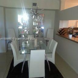 17100 North Bay Road, Unit 1402 Sunny Isles Beach, FL 33160 - Photo 9 of 25 a view of a dining room with furniture and chandelier