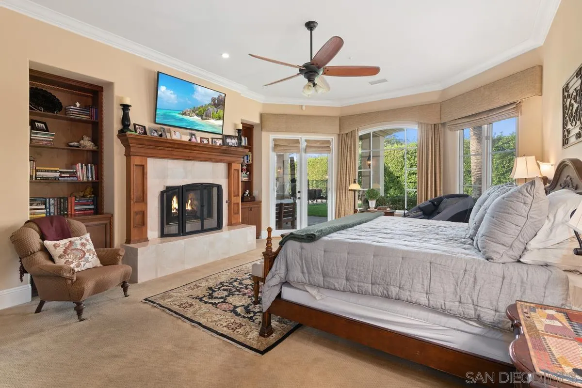 14360 Ciera Court Poway, CA 92064 - Photo 16 of 29 a bedroom with a bed a fireplace and a large window