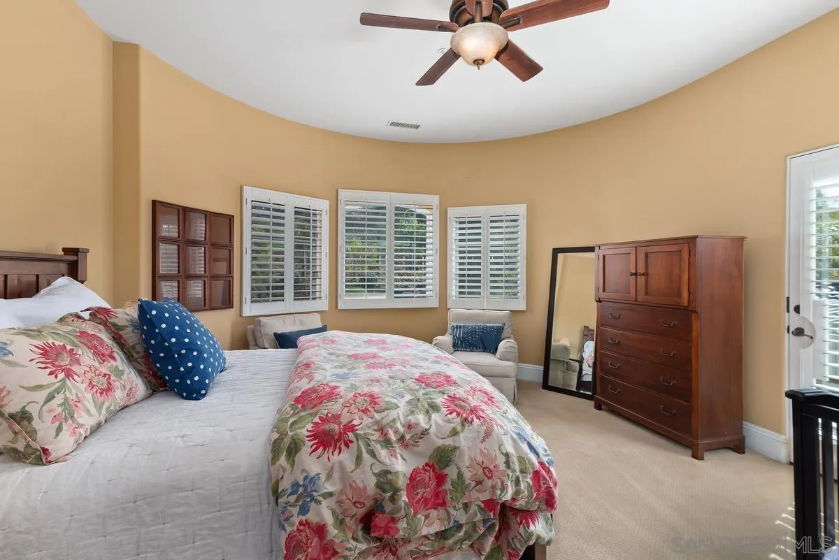 14360 Ciera Court Poway, CA 92064 - Photo 23 of 29 a bedroom with a bed and a chandelier