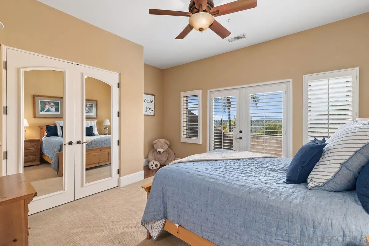 14360 Ciera Court Poway, CA 92064 - Photo 24 of 29 a spacious bedroom with a large bed and a chandelier