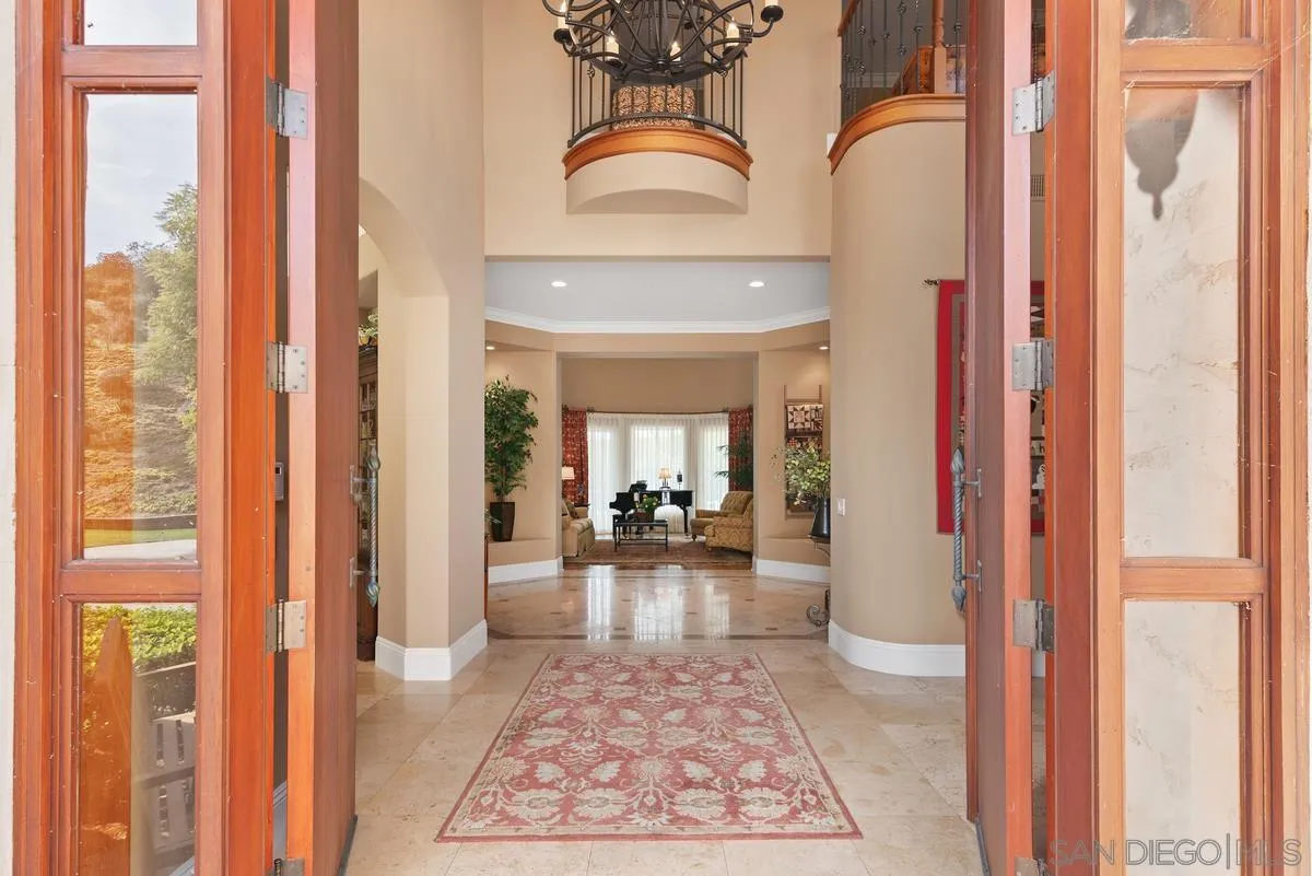 14360 Ciera Court Poway, CA 92064 - Photo 4 of 29 a view of a hallway with a dining table and sofas
