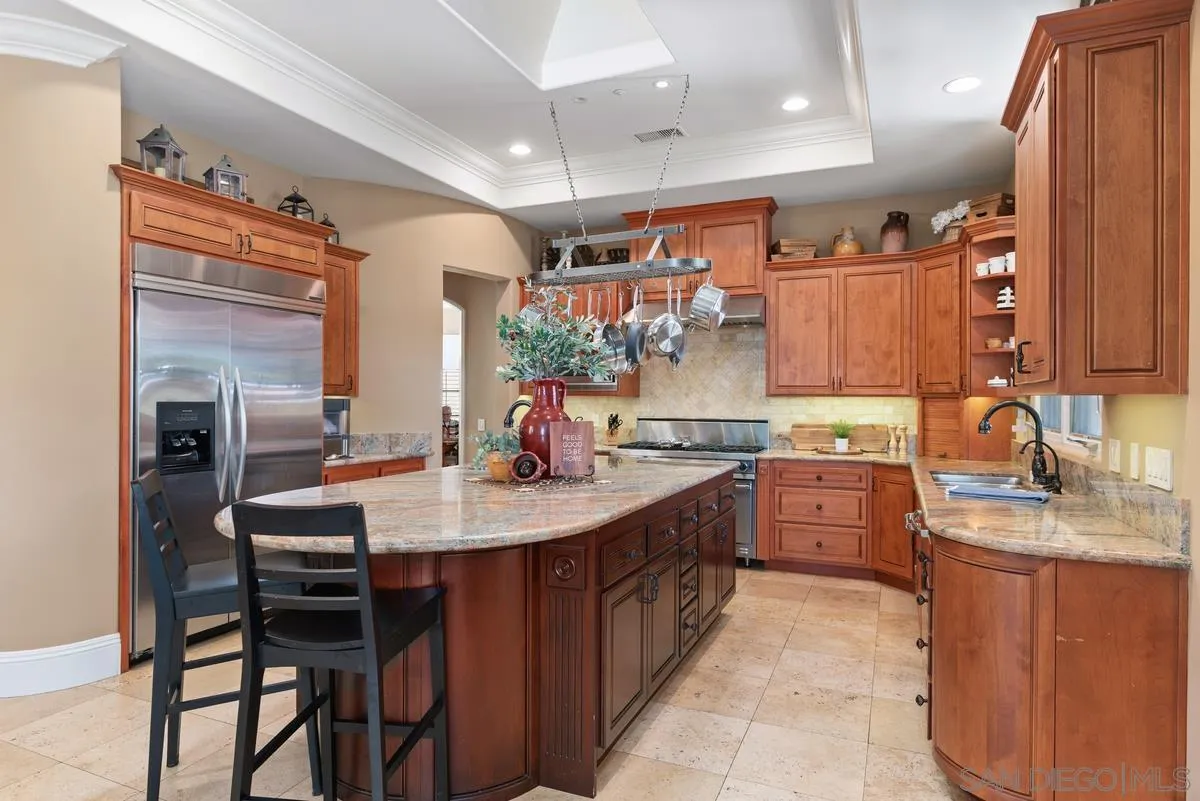 14360 Ciera Court Poway, CA 92064 - Photo 10 of 29 a kitchen with kitchen island granite countertop a sink stove and cabinets