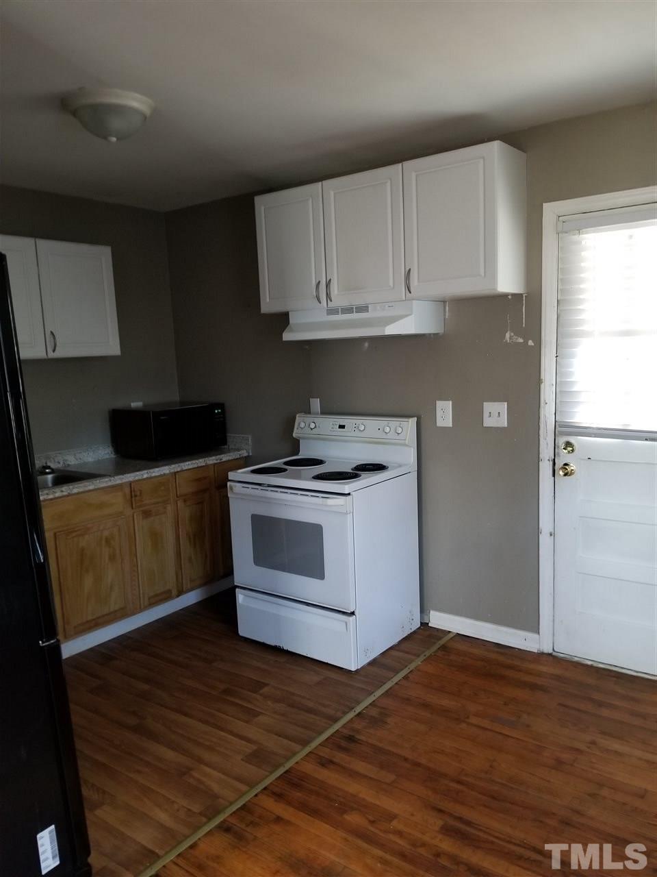 1306 Lenoir Street Raleigh, NC 27610 - Photo 2 of 7 a kitchen with granite countertop a white cabinets and white appliances
