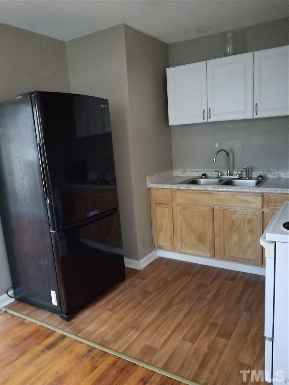 1306 Lenoir Street Raleigh, NC 27610 - Photo 3 of 7 a kitchen with granite countertop a refrigerator and a stove