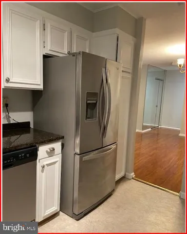 an empty room with wooden floor and entrance