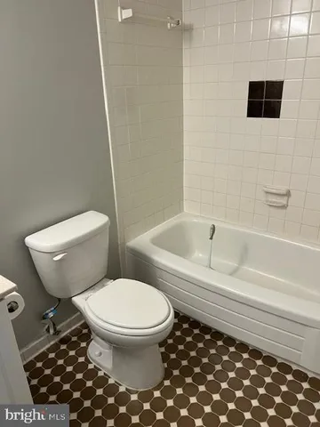 a view of a big room with windows and chandelier