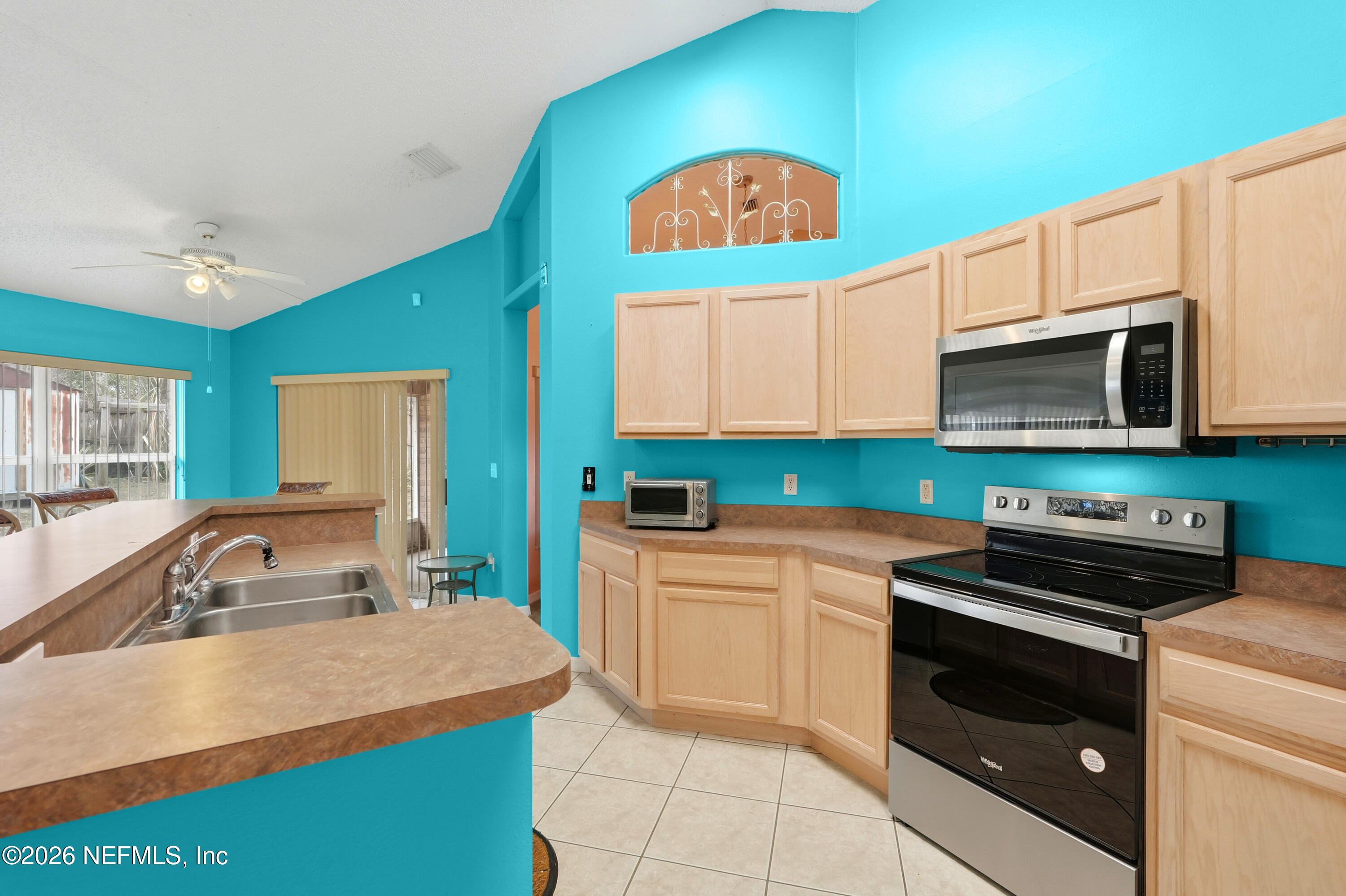 2270 Carson Lane Deltona, FL 32738 - Photo 11 of 24 a kitchen with stainless steel appliances granite countertop a sink stove and microwave