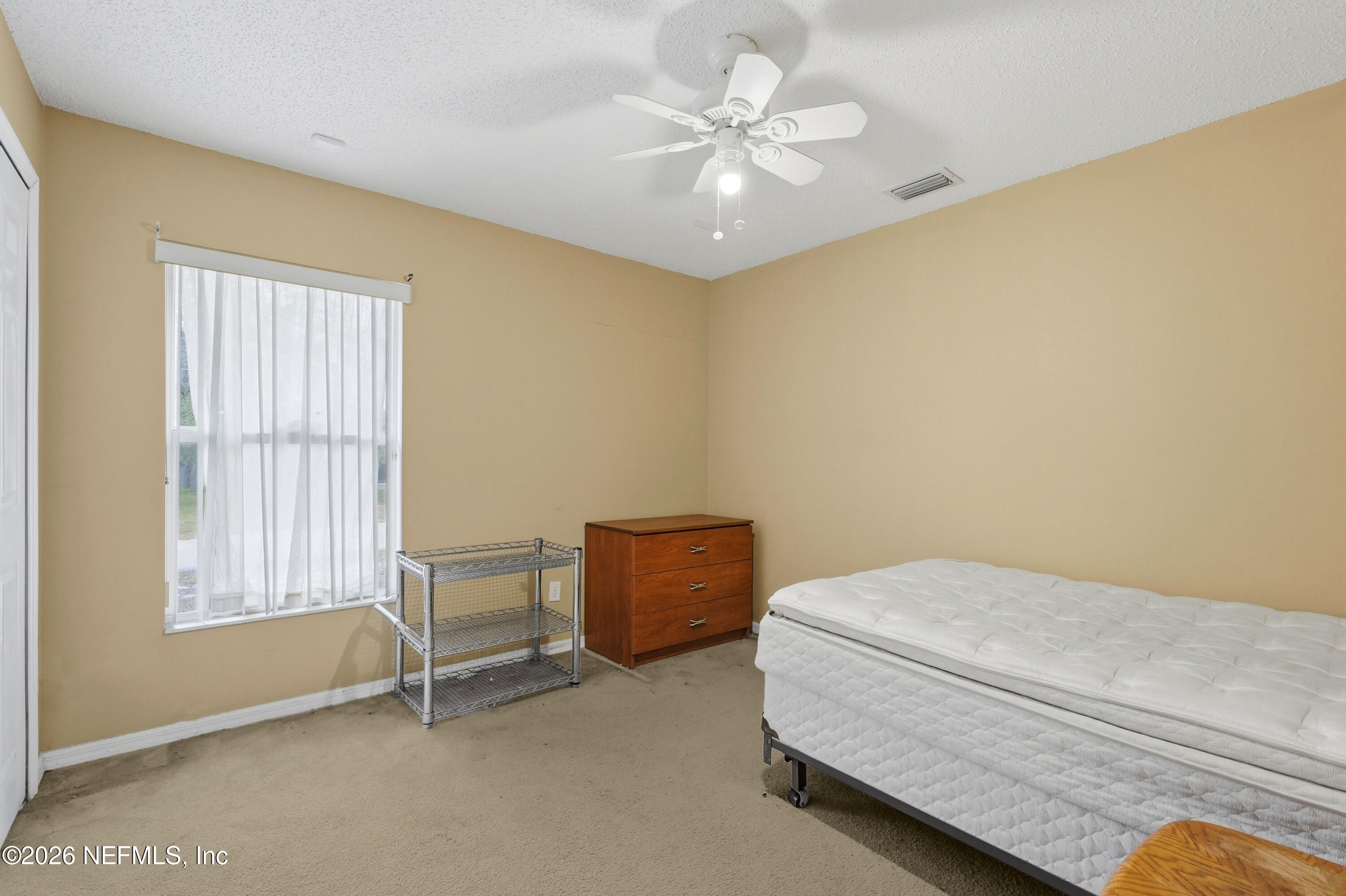 2270 Carson Lane Deltona, FL 32738 - Photo 18 of 24 a bedroom with a bed and a chair