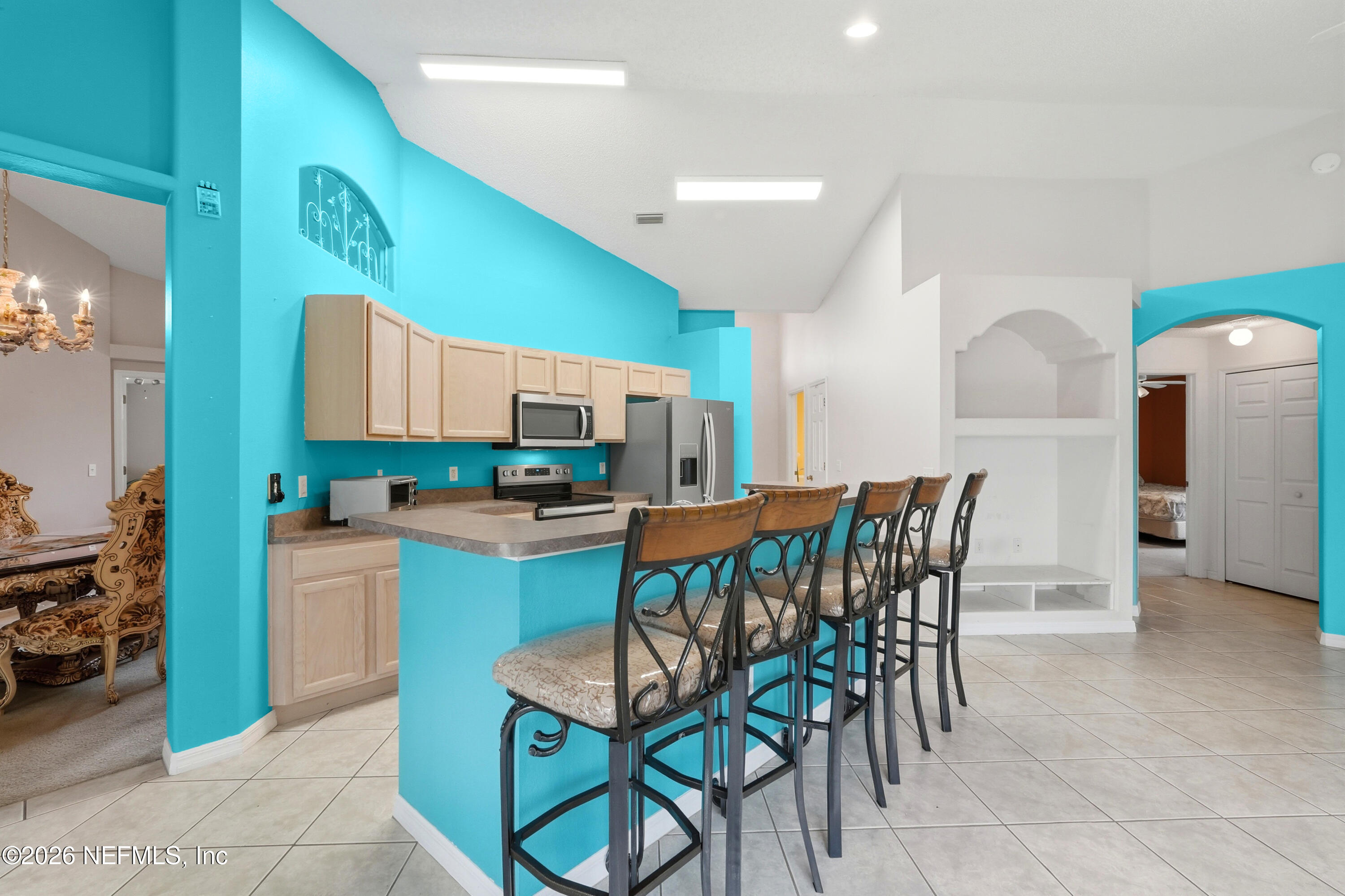 2270 Carson Lane Deltona, FL 32738 - Photo 4 of 24 a dining area with a table chairs and a kitchen view