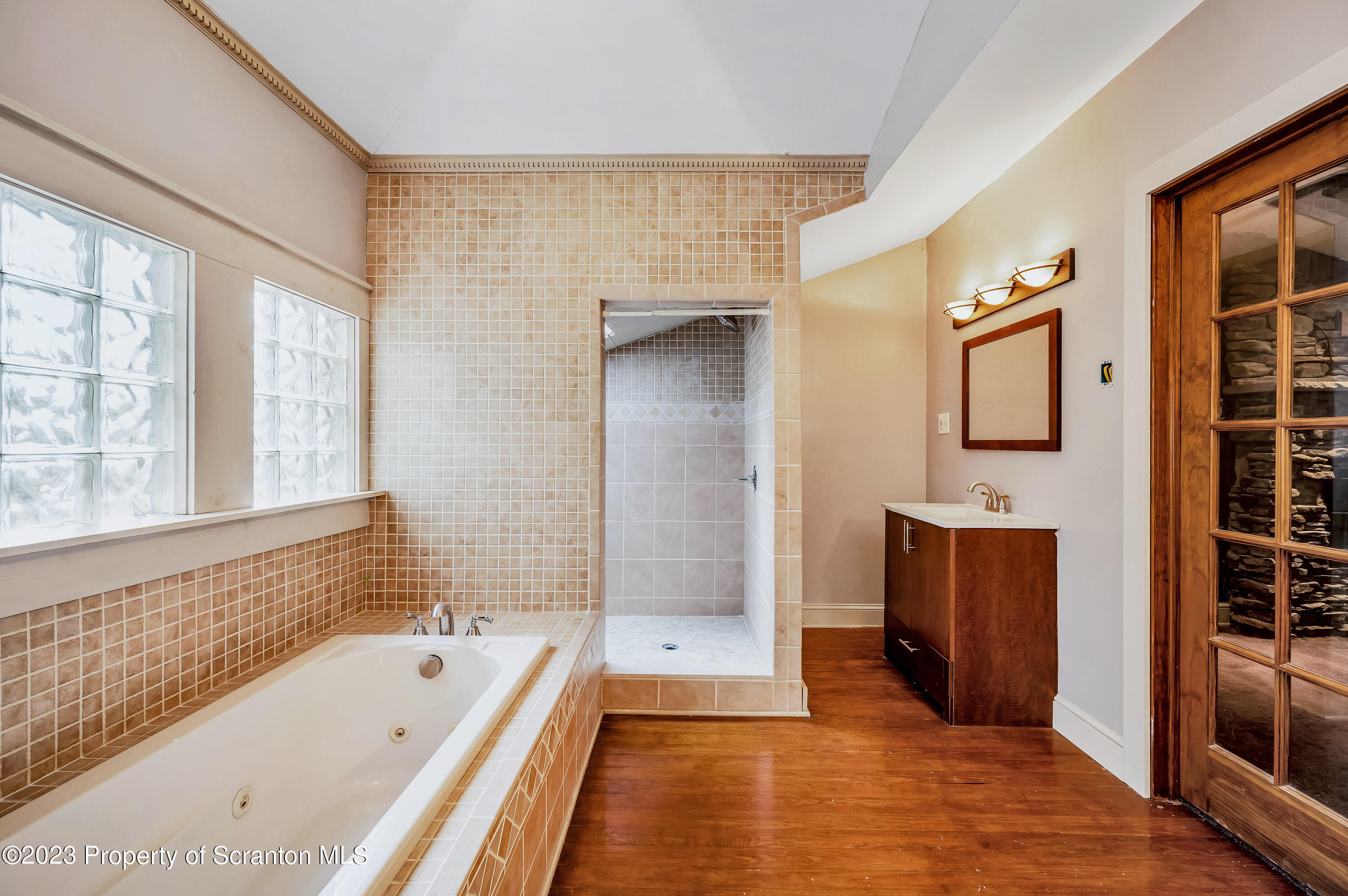 21 Ridge Street Dallas, PA 18612 - Photo 20 of 92 a bathroom with a tub a sink and a large mirror