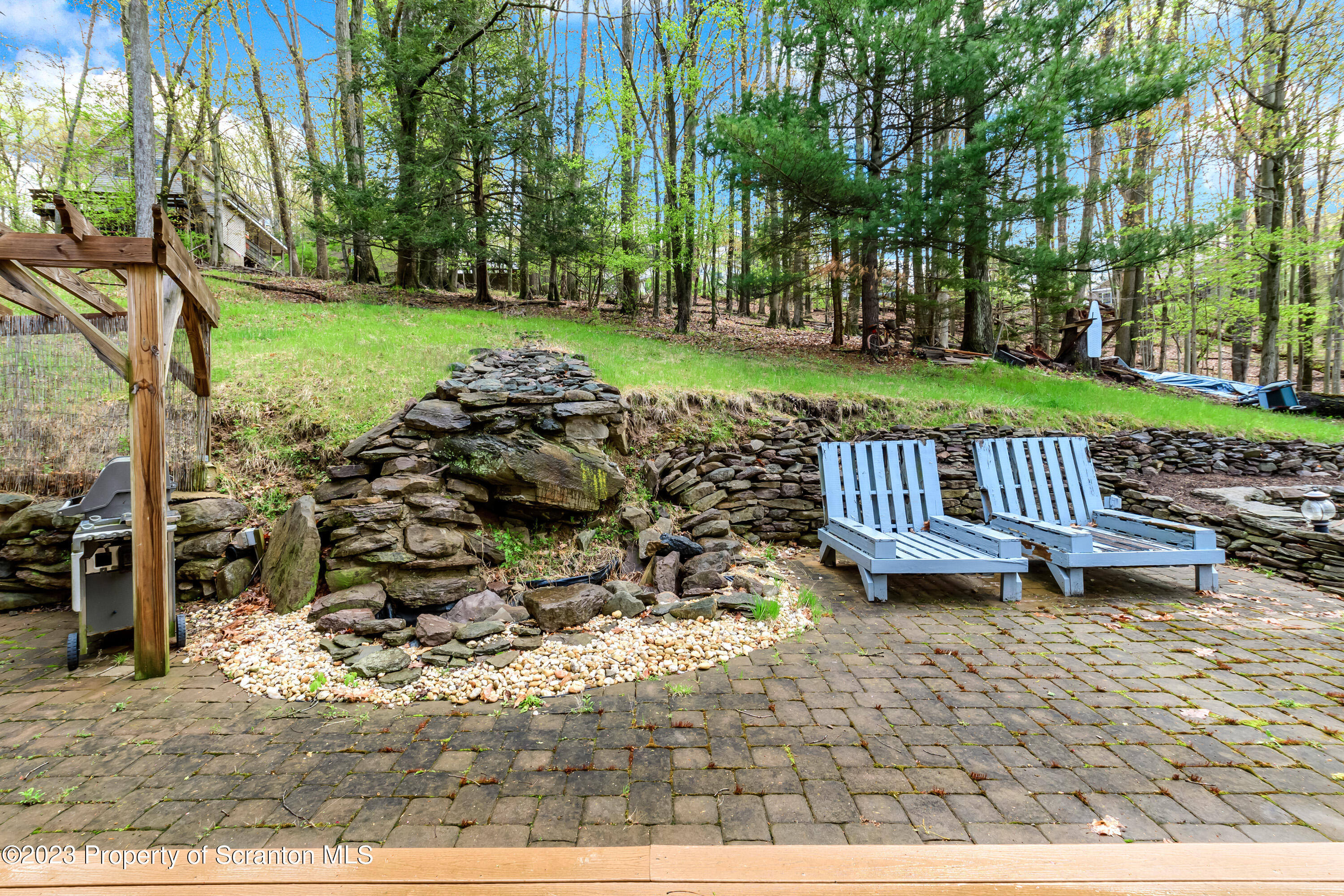 21 Ridge Street Dallas, PA 18612 - Photo 36 of 92 a view of a table and chairs in backyard of the house