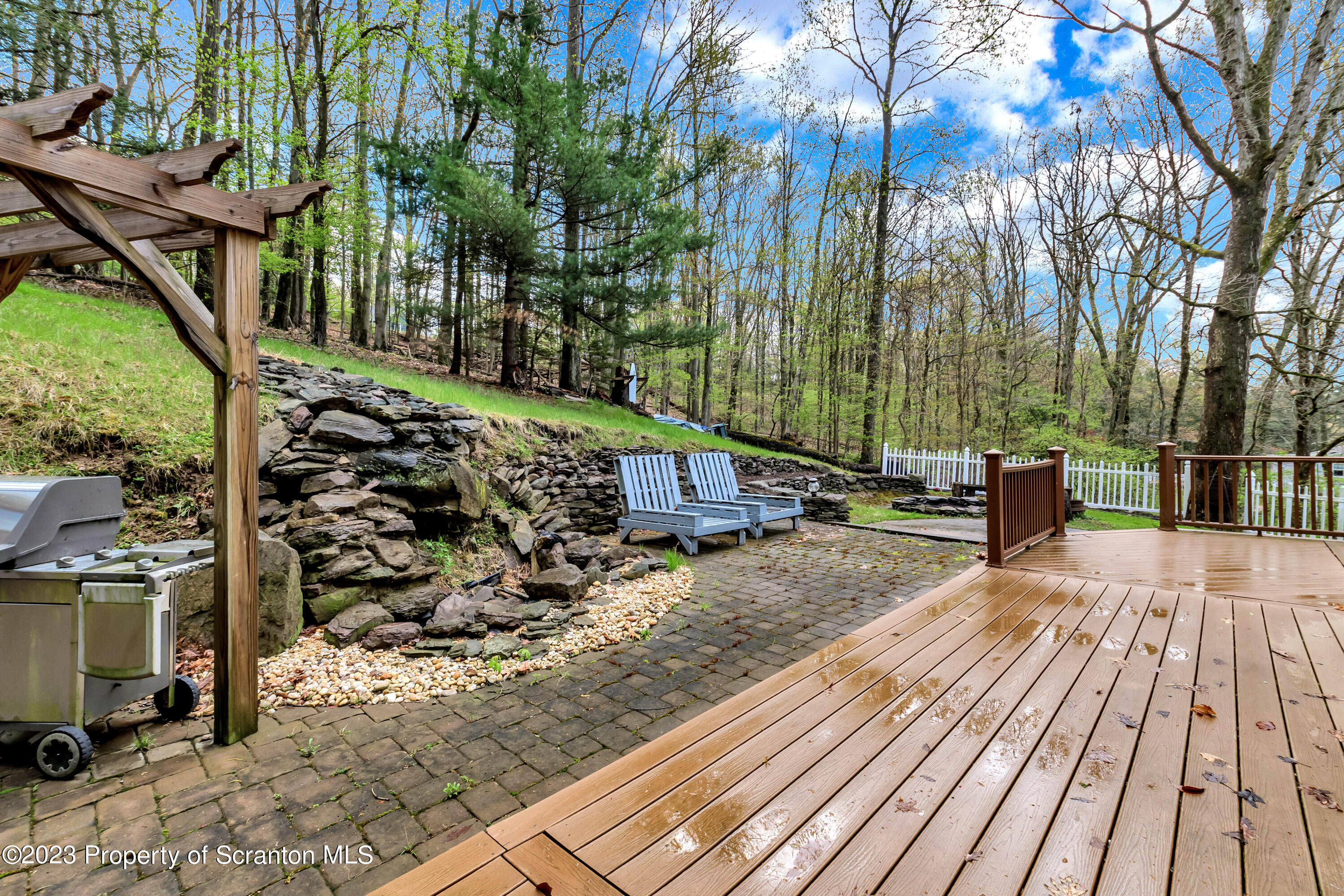 21 Ridge Street Dallas, PA 18612 - Photo 37 of 92 a view of a wooden deck with a yard