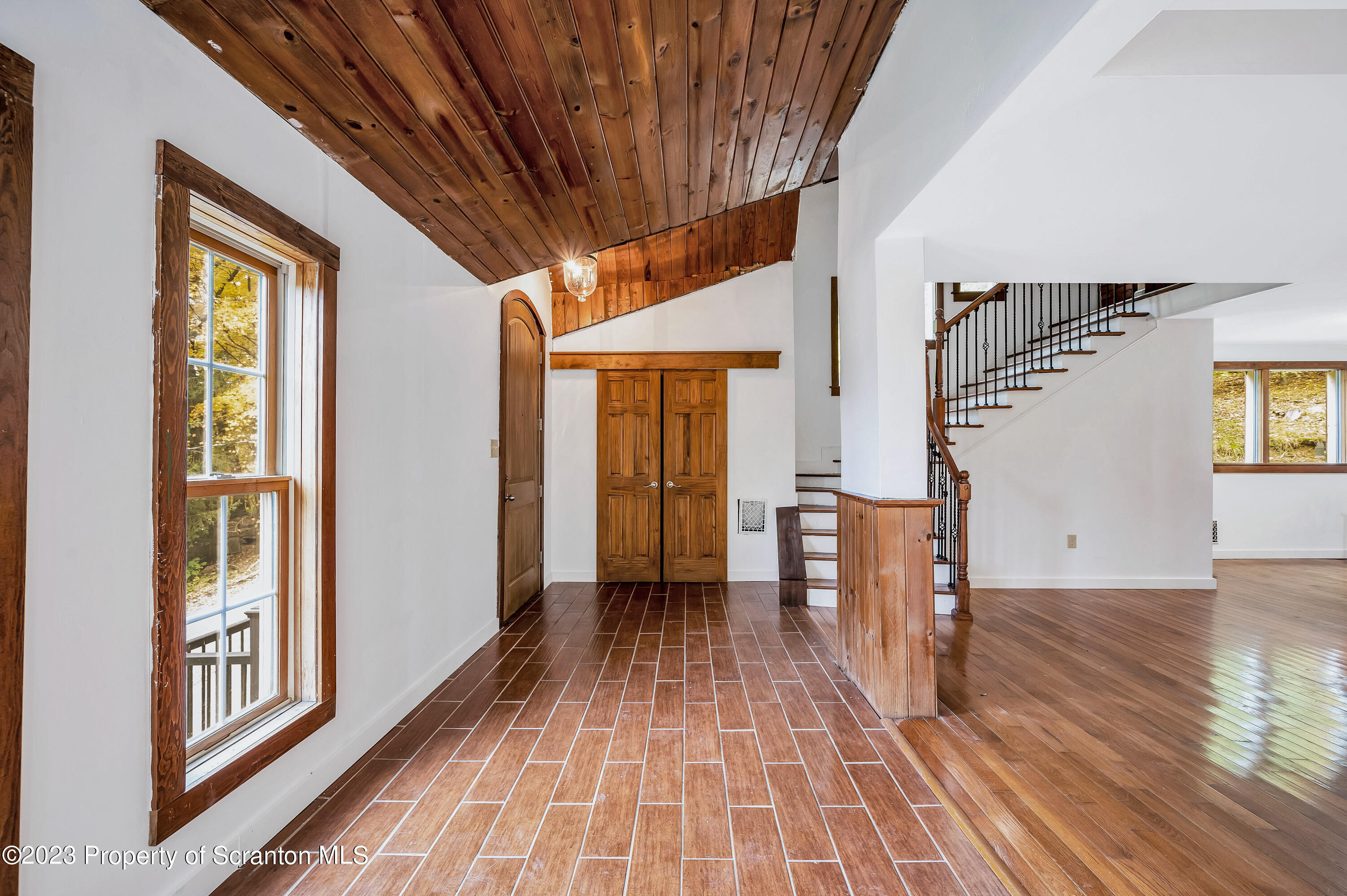 21 Ridge Street Dallas, PA 18612 - Photo 4 of 92 a view of a hallway with wooden floor and staircase
