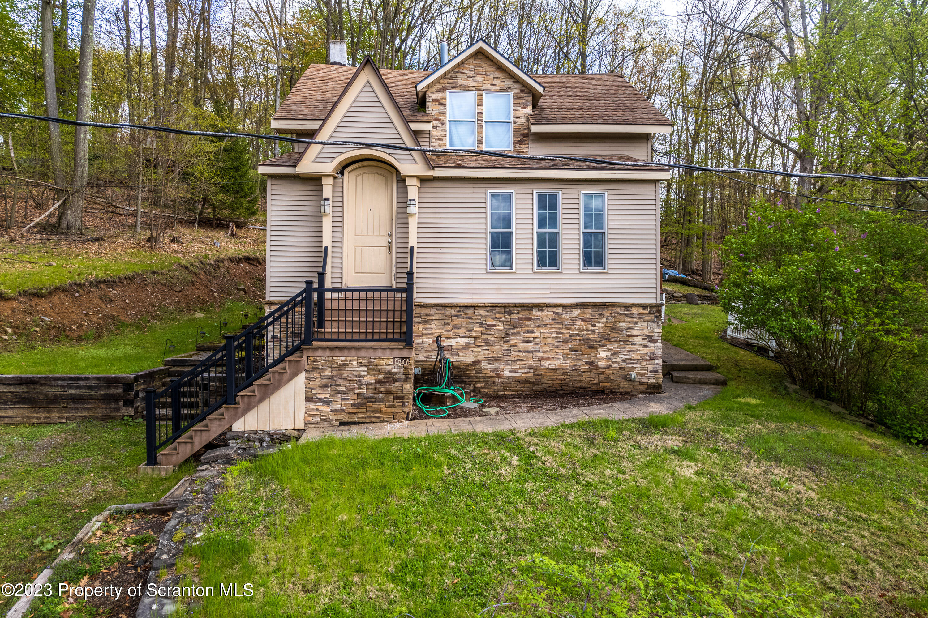 21 Ridge Street Dallas, PA 18612 - Photo 43 of 92 a front view of a house with a yard
