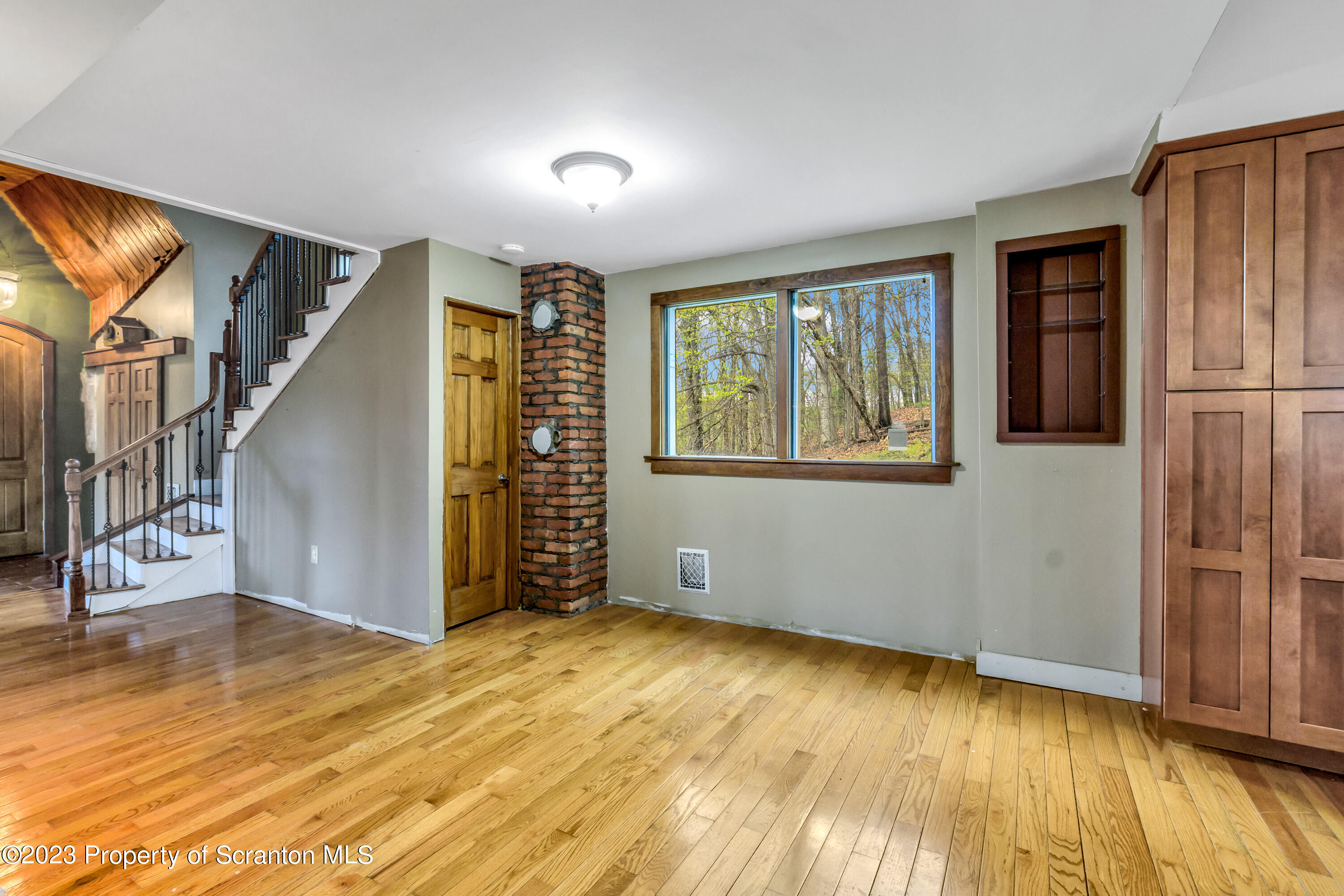 21 Ridge Street Dallas, PA 18612 - Photo 52 of 92 a view of an empty room with wooden floor and a window
