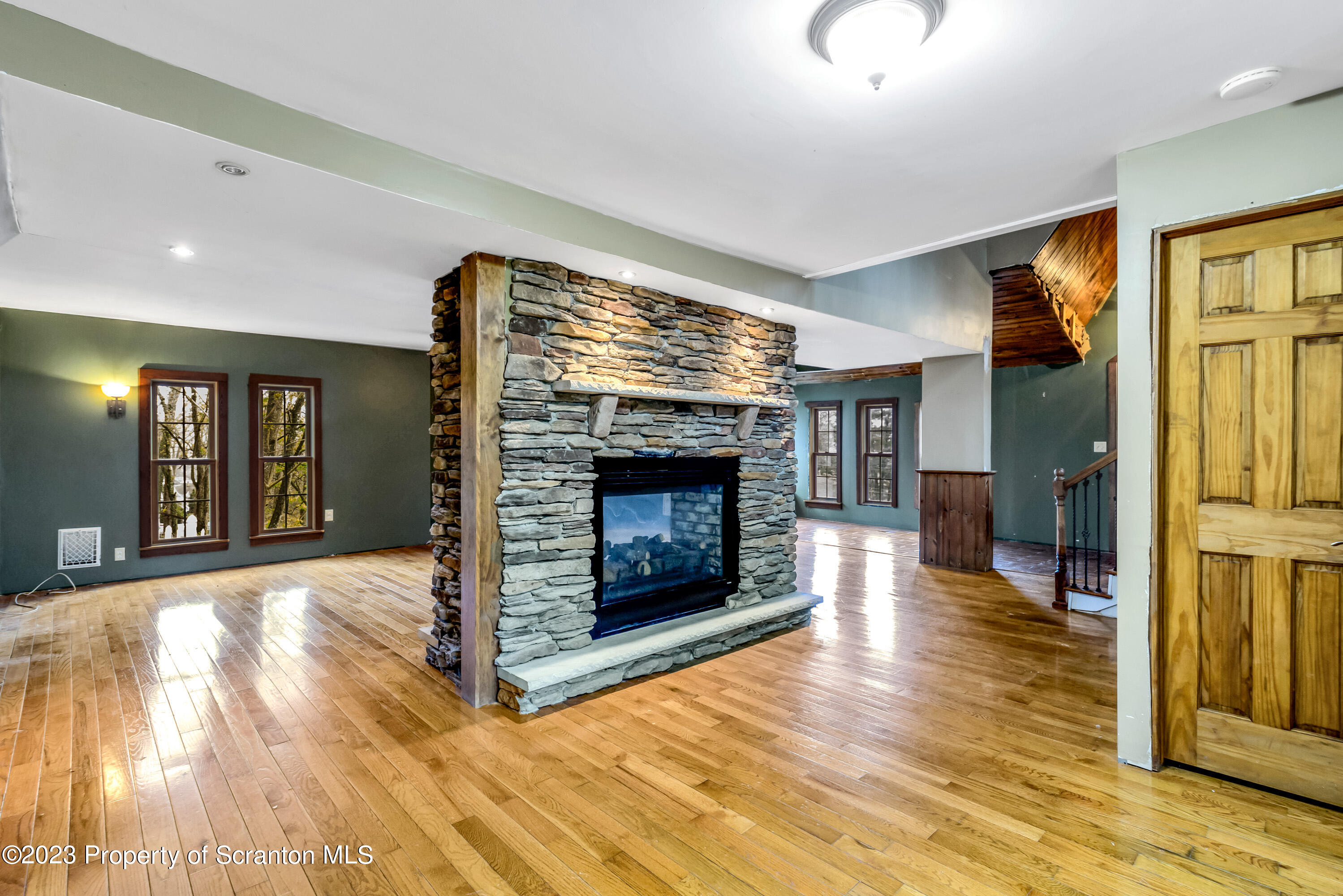 21 Ridge Street Dallas, PA 18612 - Photo 54 of 92 a view of a livingroom with wooden floor and a fireplace