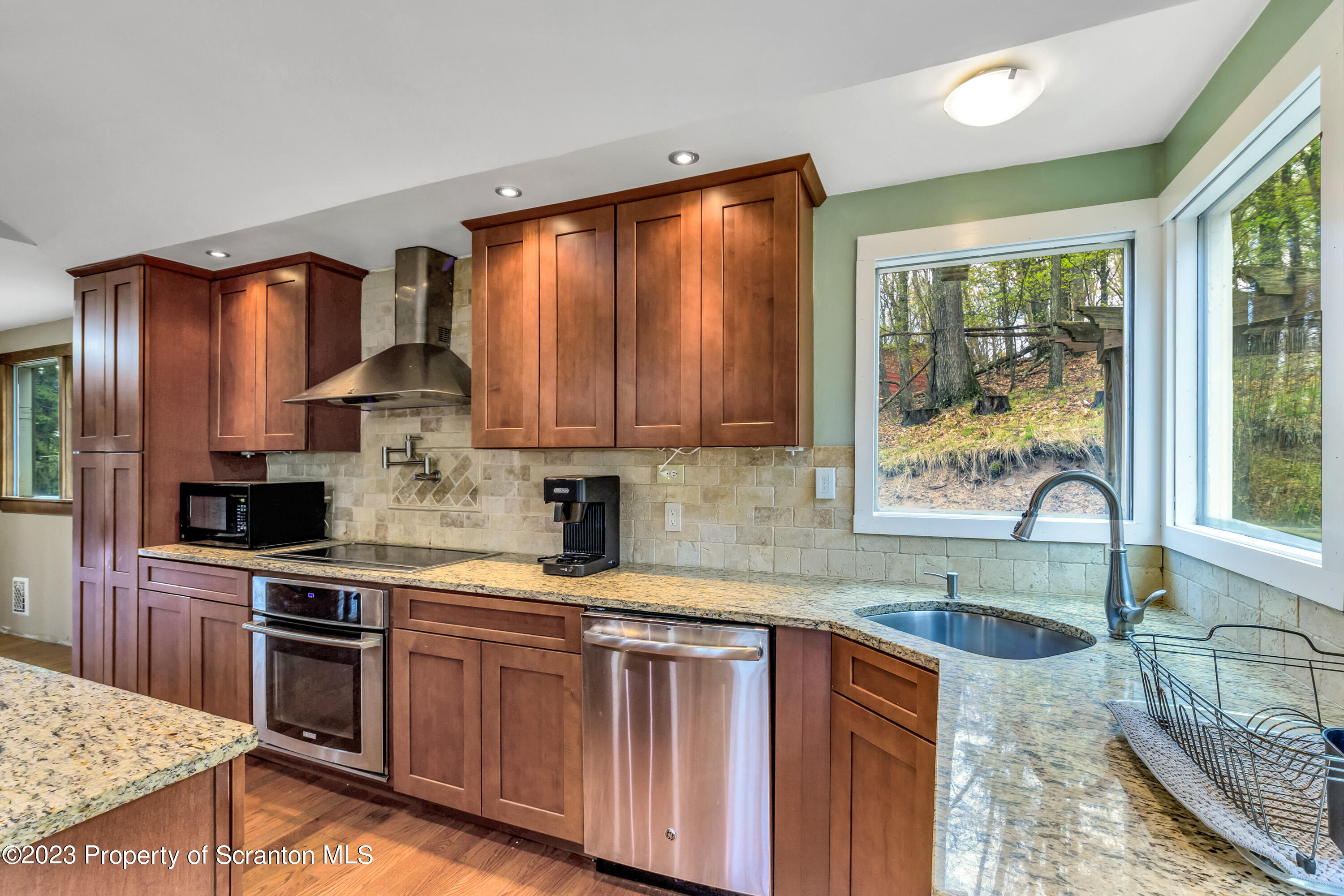 21 Ridge Street Dallas, PA 18612 - Photo 59 of 92 a kitchen with kitchen island granite countertop a sink cabinets and stainless steel appliances