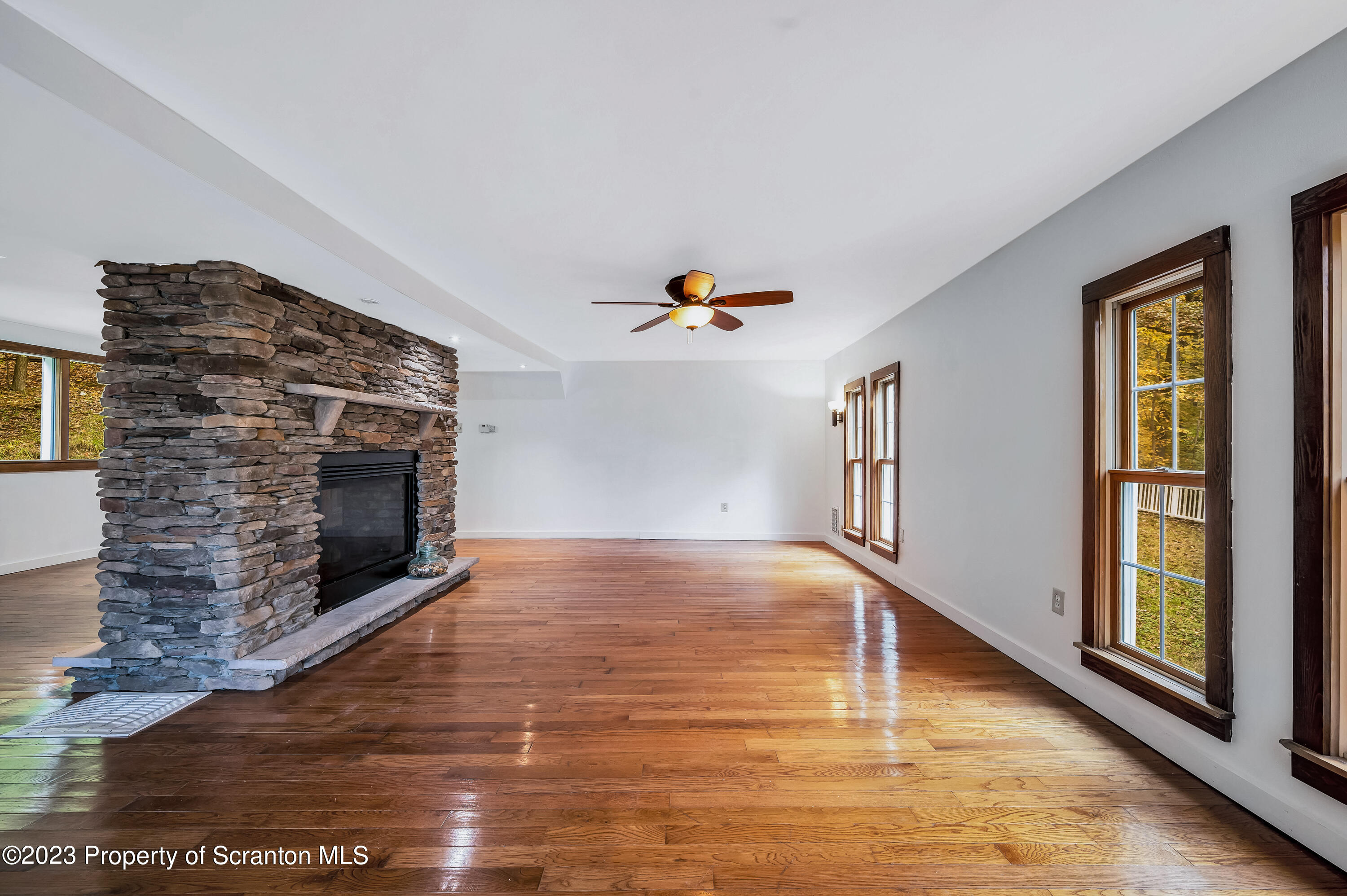 21 Ridge Street Dallas, PA 18612 - Photo 6 of 92 a view of empty room with wooden floor and fireplace