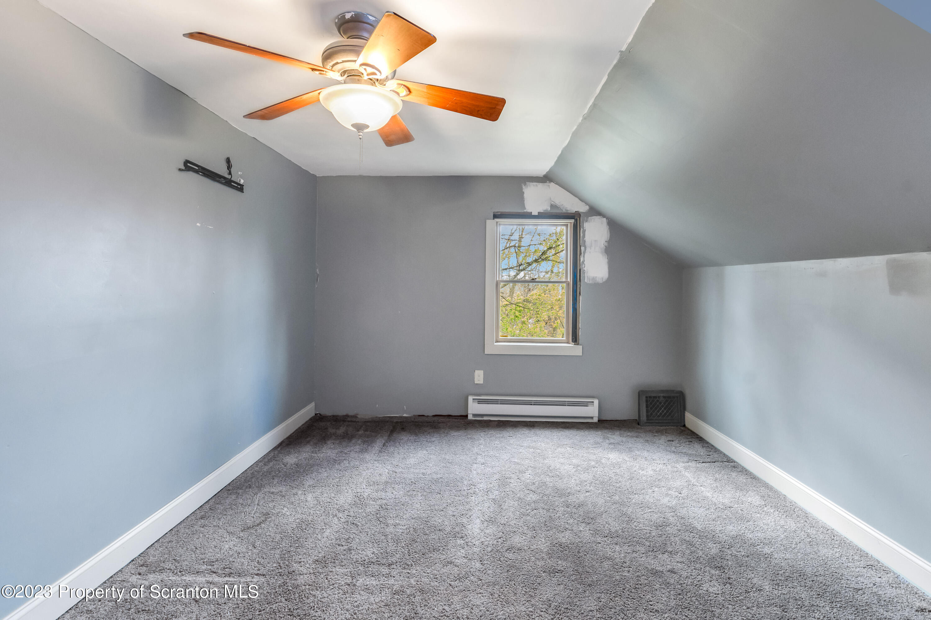 21 Ridge Street Dallas, PA 18612 - Photo 78 of 92 an empty room with windows and fan