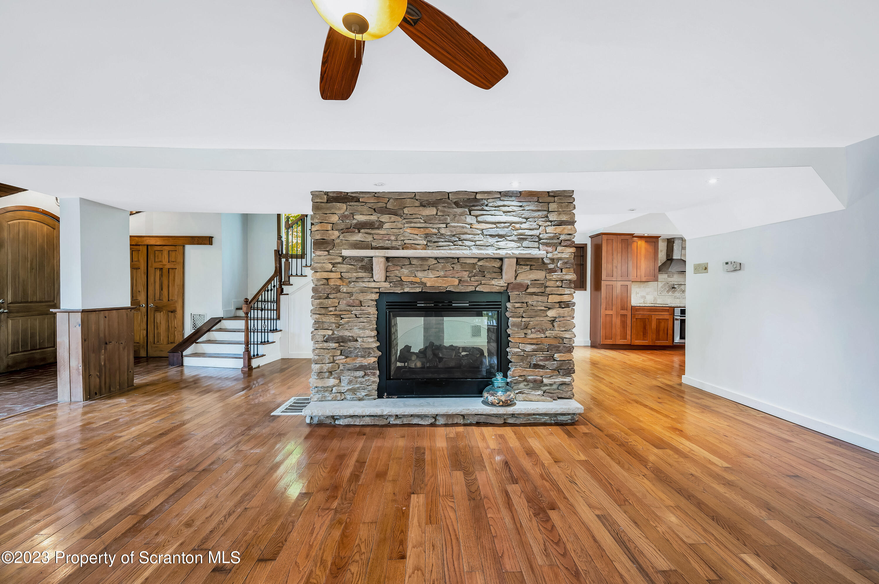 21 Ridge Street Dallas, PA 18612 - Photo 8 of 92 an empty room with wooden floor fireplace and windows