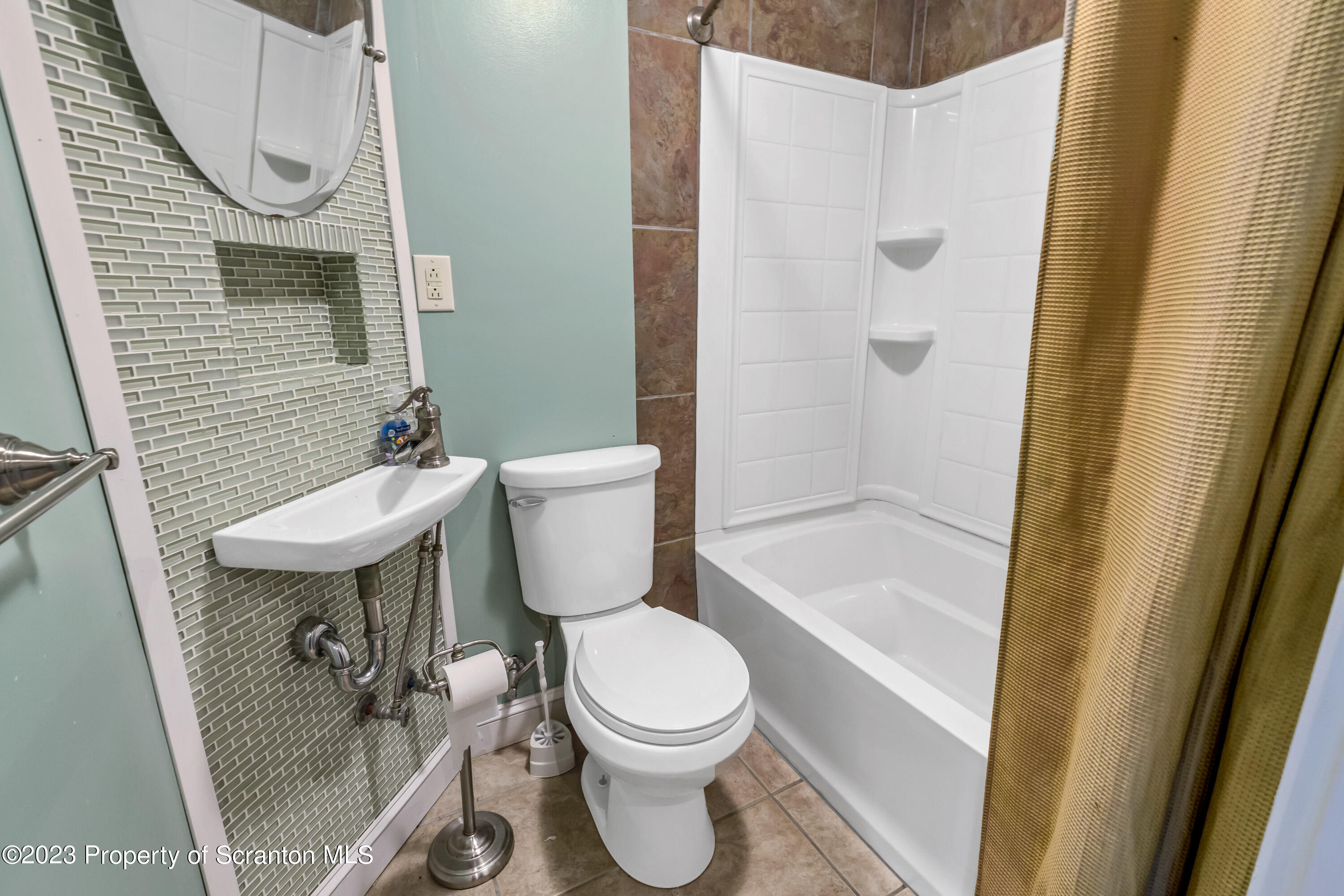 21 Ridge Street Dallas, PA 18612 - Photo 88 of 92 a white toilet sitting next to a bathroom sink and tub