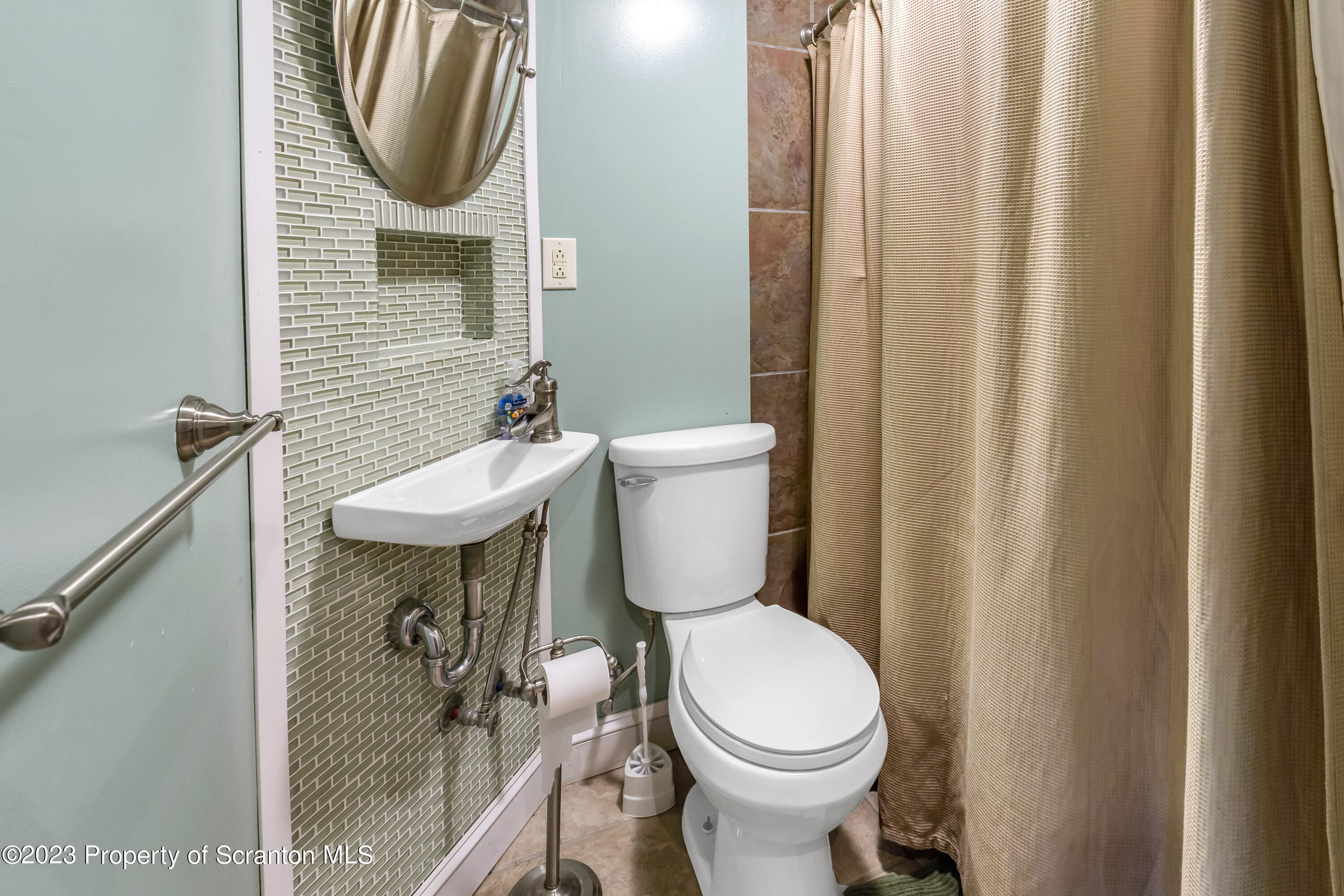 21 Ridge Street Dallas, PA 18612 - Photo 89 of 92 a bathroom with a sink a toilet and a mirror