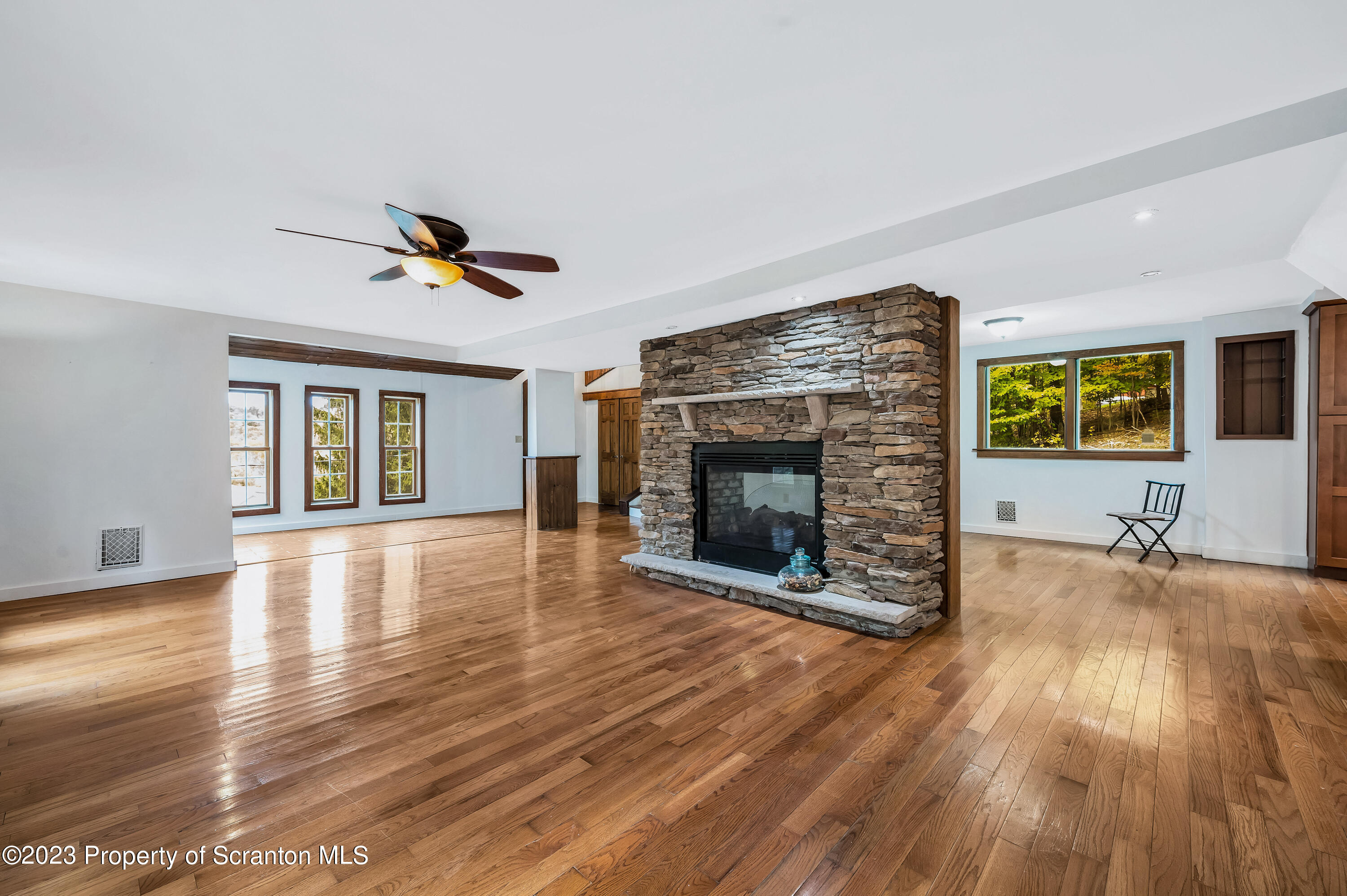 21 Ridge Street Dallas, PA 18612 - Photo 9 of 92 a view of empty room with wooden floor and fireplace