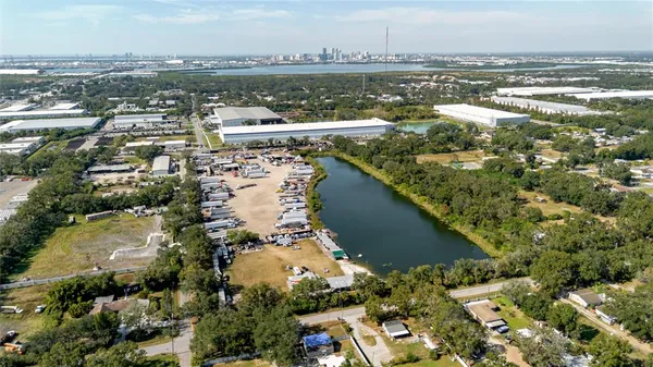 an aerial view of residential houses with outdoor space and lake view