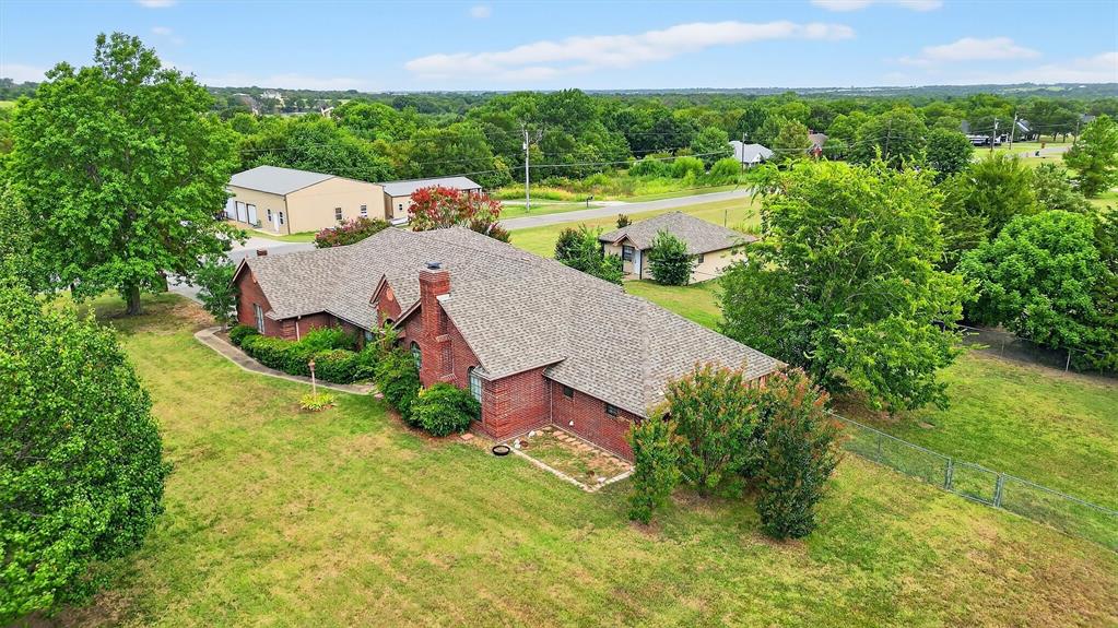 443 Lakewood Road Denison, TX 75020 - Photo 1 of 38 an aerial view of a house with a garden and swimming pool