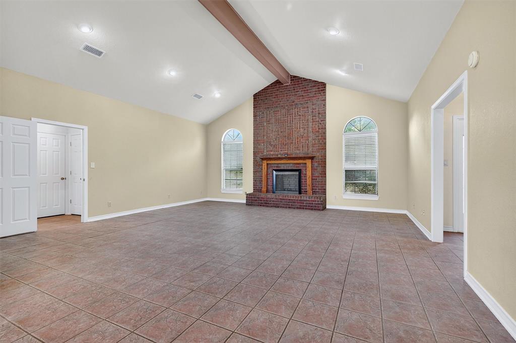 443 Lakewood Road Denison, TX 75020 - Photo 13 of 38 an empty room with windows and fireplace