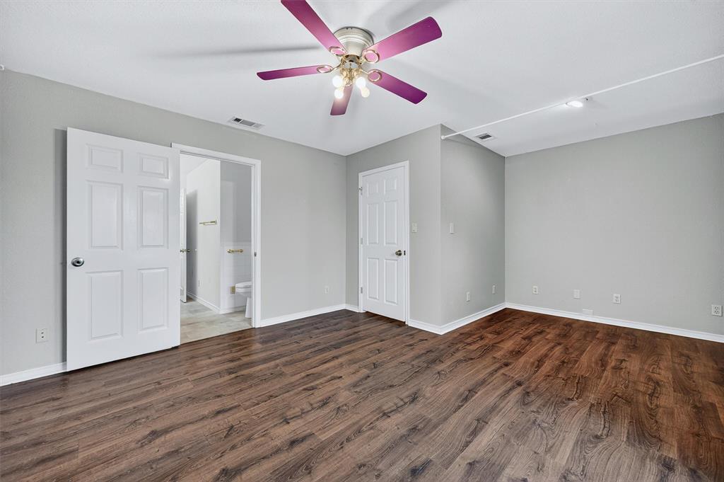 443 Lakewood Road Denison, TX 75020 - Photo 18 of 38 a view of an empty room with window and wooden floor