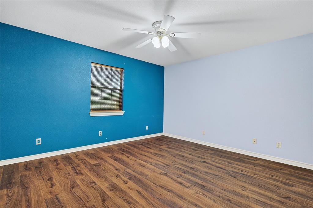 443 Lakewood Road Denison, TX 75020 - Photo 22 of 38 wooden floor in an empty room with a window